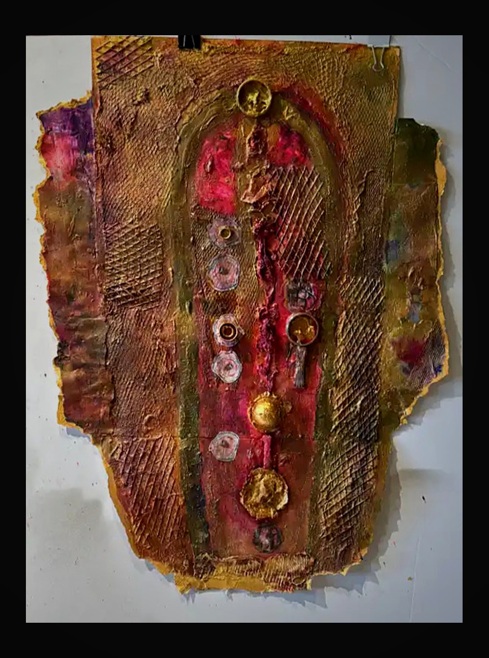 Arched form with crimson interior, gold border, and jewel-like circular elements descending its center