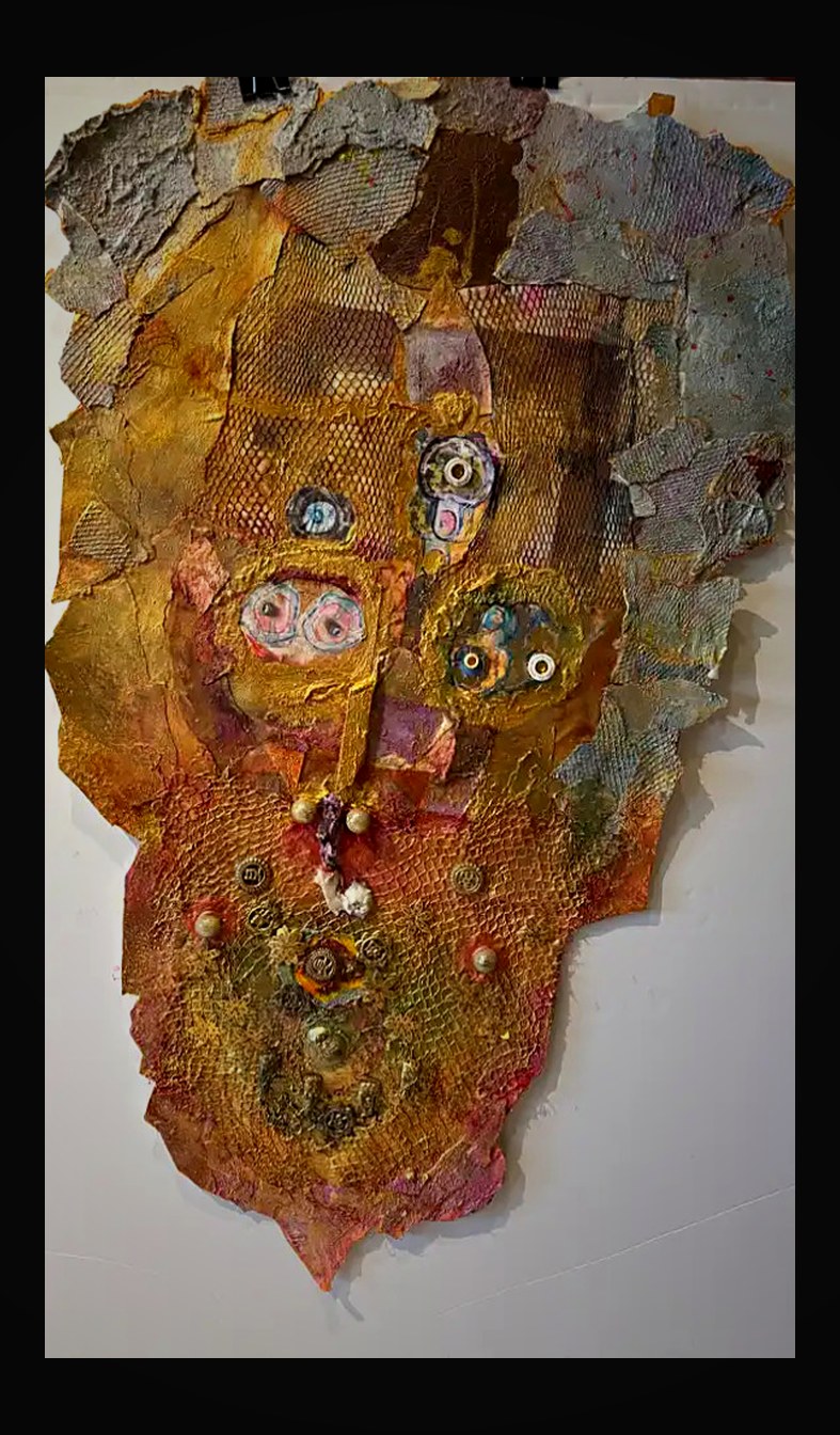 Intricate face form with mesh overlay, golden patina, and found-object medallions