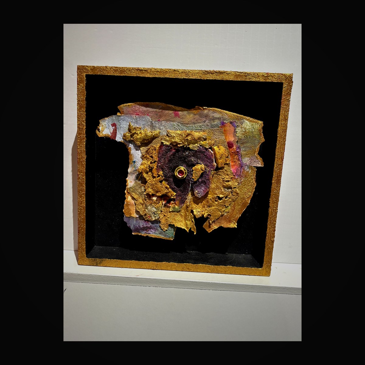 Shadow box with amethyst purple center and gold leaf surround with ruby accent