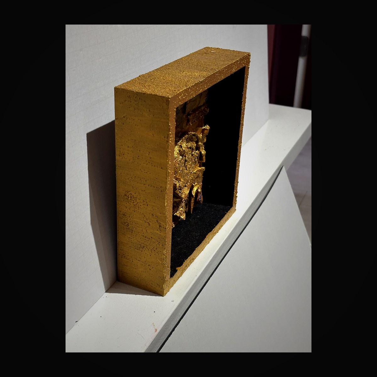 Golden casket shadow box with textured gold leaf surface