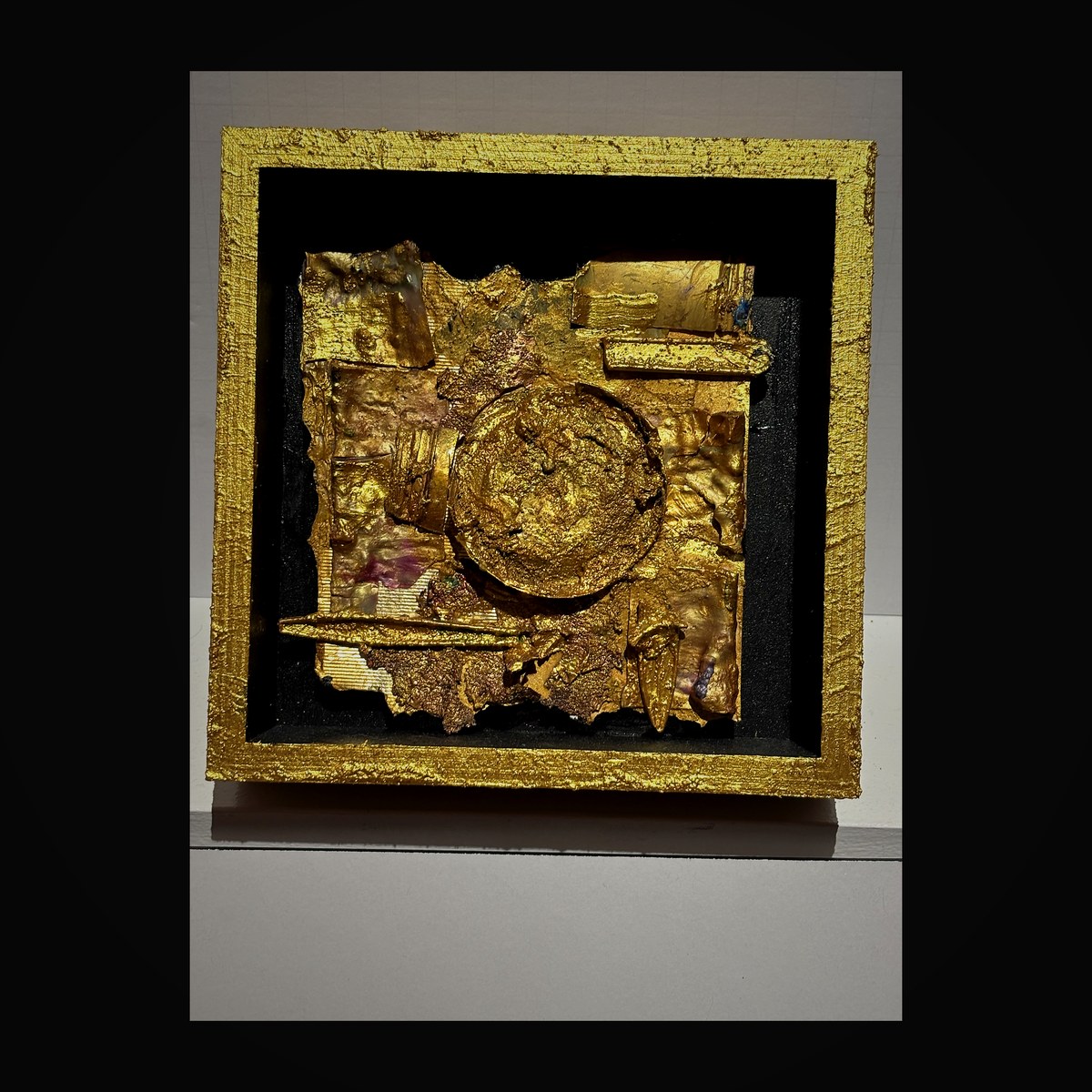 Shadow box featuring central golden disc with rich amber and copper enamel