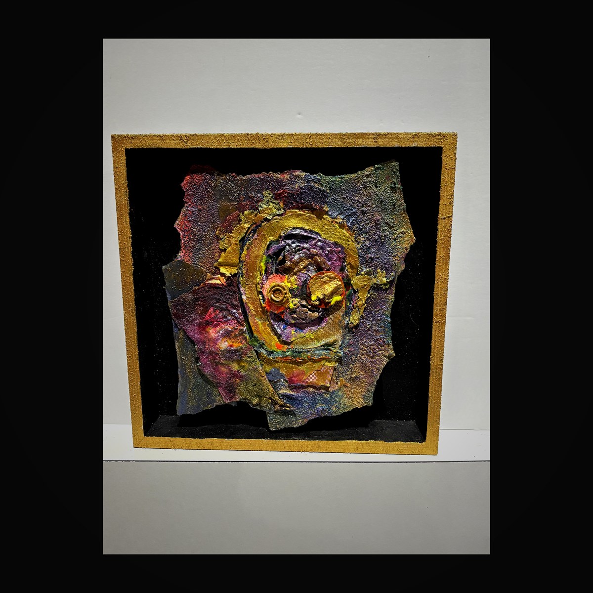 Shadow box with swirling gold and purple enamel forming a nebula-like spiral